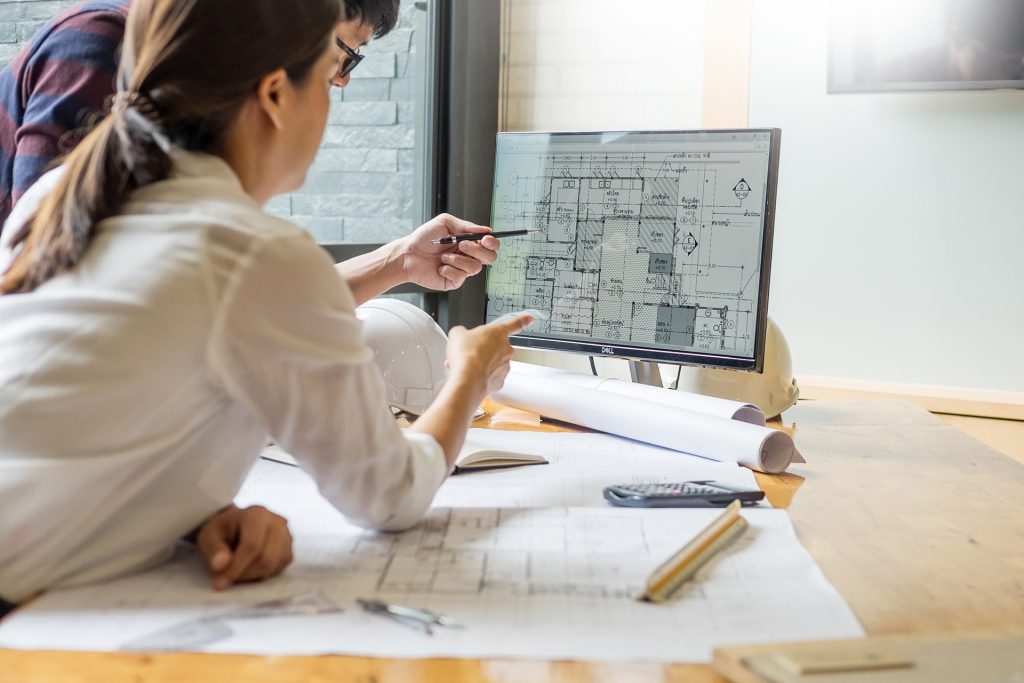 Image showing general contractors discussing blueprints for a construction project