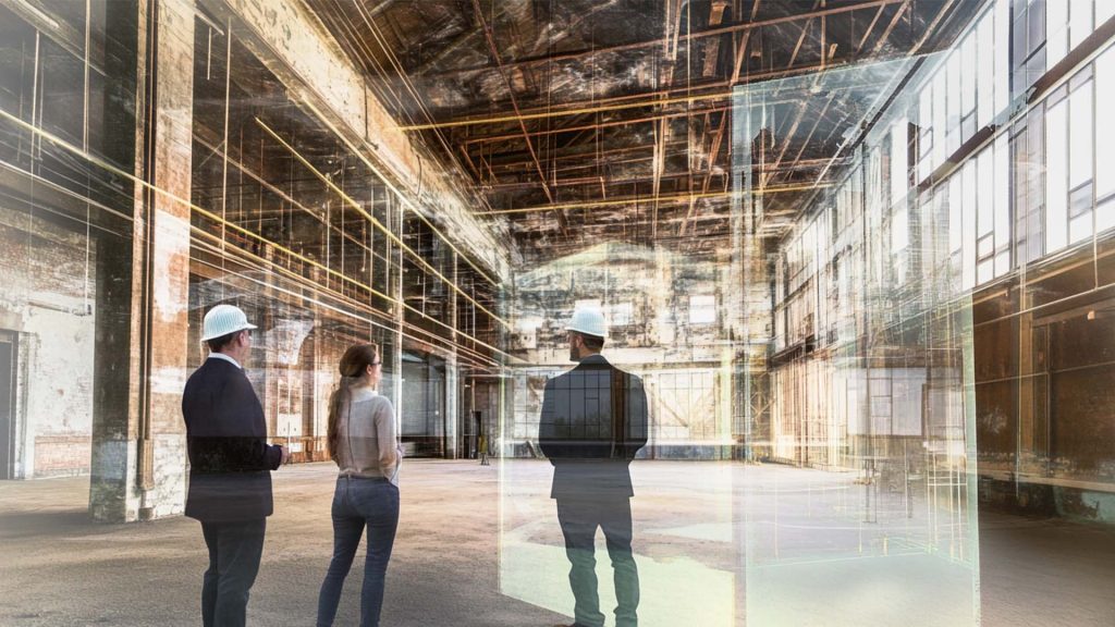 business owner and architects discussing adaptive reuse project inside of old warehouse